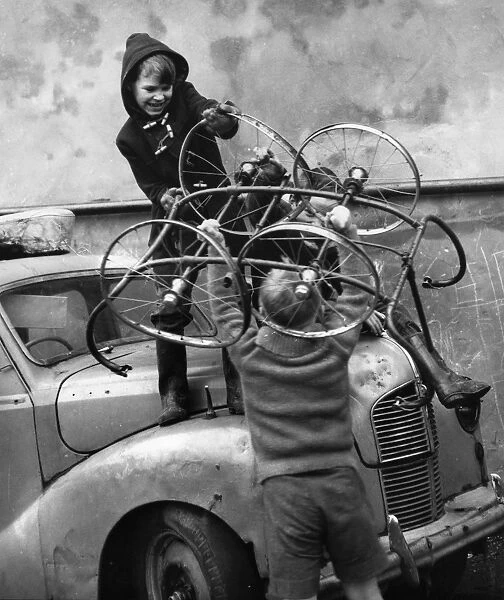 Boys with pram wheels and car in Balham street, SW London