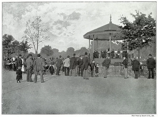 Crowd listening to live music on the bandstand in Battersea Park, London. Date: late 1890s