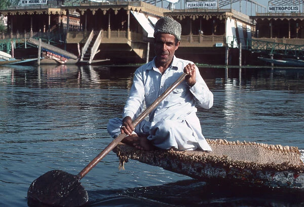 Lake Dal, Srinagar, Kashmir - a man paddling boat