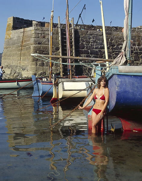 Young woman in bikini, Coverack, Cornwall
