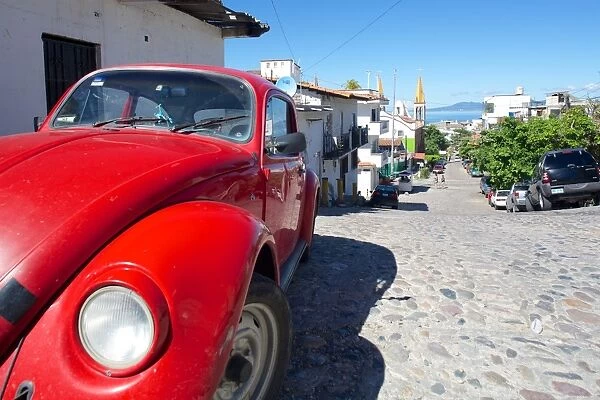 Red Volkswagen Beetle in residential street, Downtown, Puerto Vallarta, Jalisco, Mexico, North America