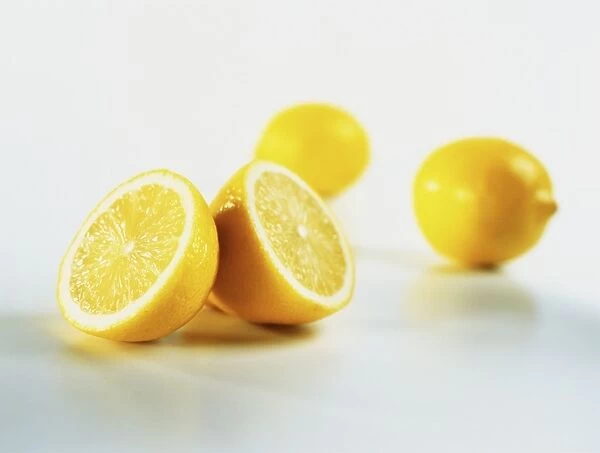 Two whole lemons, one cut in half