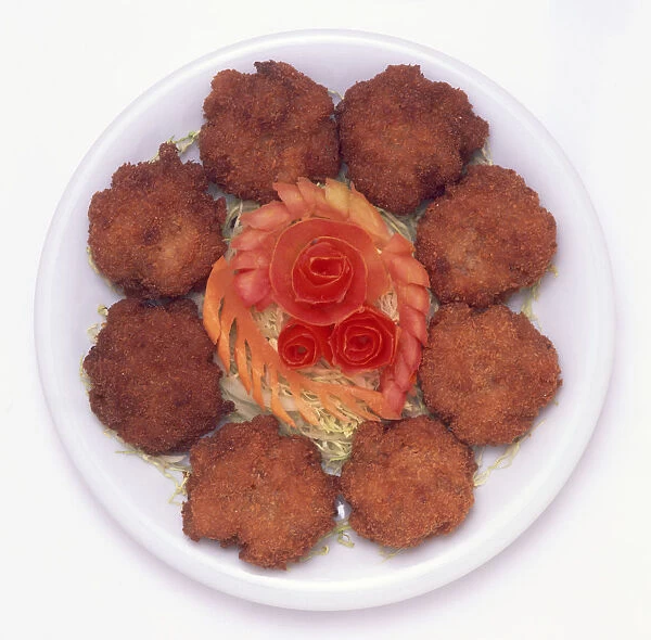 Plate of Thot Man Kung, deep-fried prawn cakes with vegetable decorations, a typical dish from Southern Thailand, view from above