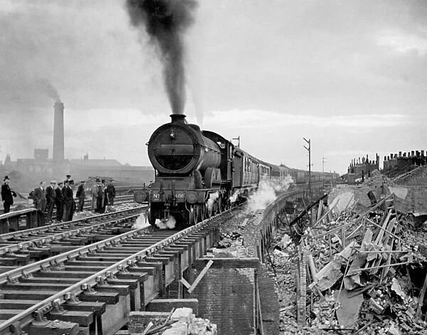 First train to pass over repaired bridge between Liverpool St and Stratford damaged by flying bomb