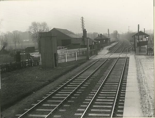 View looking west at Burnt Mill station showing the level crossing and signal box