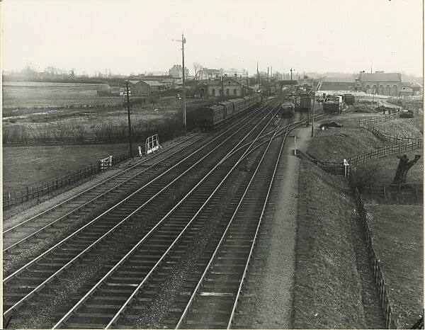 View looking west through Harlow station. Passenger train on down refuge siding
