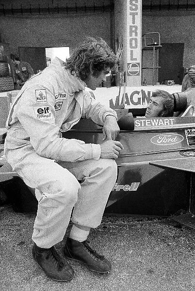 Formula One World Championship: fifth placed Francois Cevert Tyrrell talks with fourth placed team mate and World Champion Jackie Stewart Tyrrell