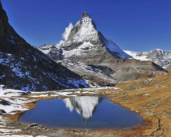 Matterhorn reflected in Lake Riffelsee, Zermatt, Alps, Valais, Switzerland