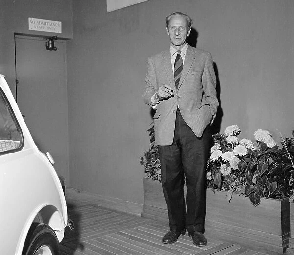 Designer of the British mini motor car Alec Issigonis, with one of the first cars which