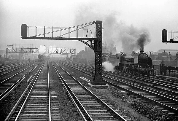Steam locomotives and trains seen here on the approaches to Waterloo Station. Circa 1935