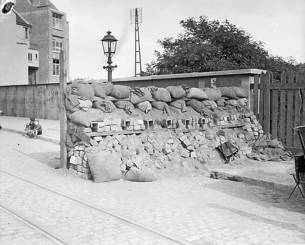 Street barricade made from sacks and bricks set across one of the approach roads to