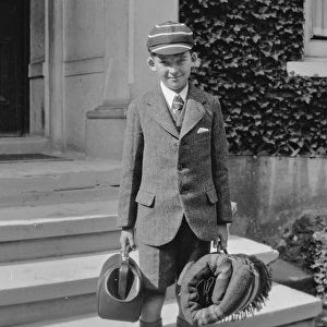 Boy in school uniform with luggage