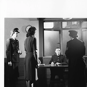 Police officers with woman in police station, London