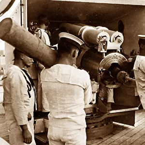 Royal Navy sailors ramming home a projectile probably 1930s