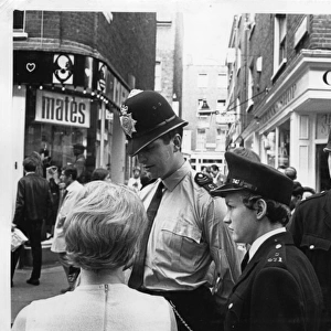 Woman police officer in street, London