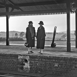 Two women on railway station platform