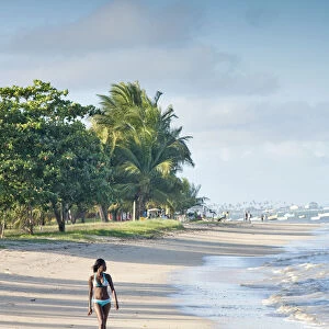 South America, Brazil, Bahia, a black Brazilian model in a bikini woman walks along