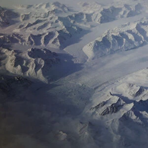 A glacier is seen making a path through mountains on the eastern coast of Greenland