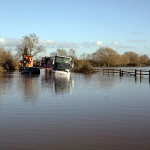Stranded school bus in flooded rural road, Soar Valley, Leicestershire, England, November 2012