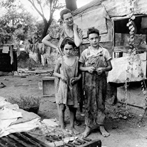 POVERTY: FAMILY, 1936. An impovised mother with her son and daughter in a shantytown