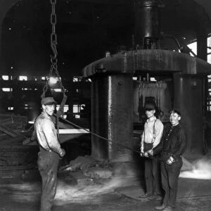 STEEL WORKERS, c1907. Workers shearing hot slabs of steel at an American foundry, c1907