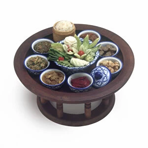 Khantoke-style table arrangement, consisting of bowls of food on a circular table, typical for Northern Thailand, high angle view