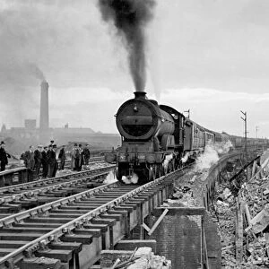 First train to pass over repaired bridge between Liverpool St and Stratford damaged by flying bomb