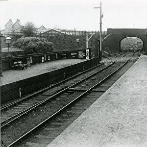 Looking west through road overbridge at Dunmow Station about 1911. Main (down side) buildings