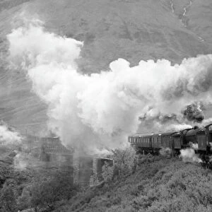 Photograph by Cyril Herbert showing a steam locomotive pulling an express train in