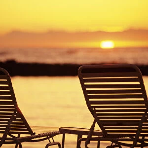 Hawaii, Two Silhouetted Chairs On Beach At Sunset, View From Behind