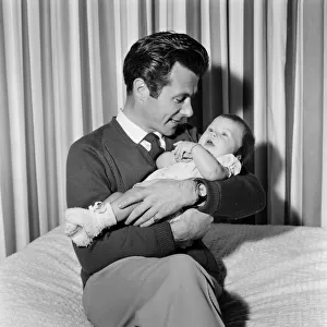 Bryan Forbes with his baby daughter Sarah Kate, at their home in Virginia Water, Surrey