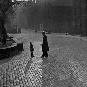Edinburgh street scenes, Policeman talking to lost child on a cobbled street in