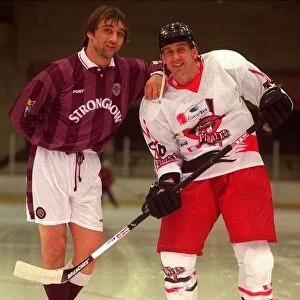 Gary Mackay of Hearts leaning on Paisley pirates Paul Hand on ice rink