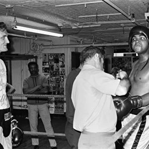 Muhammad Ali (right) getting ready to spar with a young Joe Bugner at a gym in New York