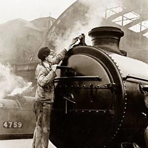 One of the new Merchant Navy Class Engines having its front lamp cleaned by the engine