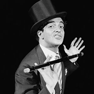 Singer Frankie Vaughan on stage performing in top hat and holding a cane