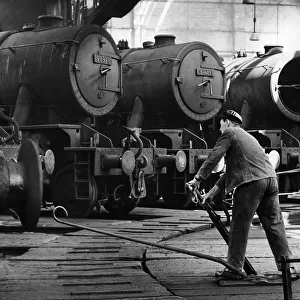 Steam Trains. A driver prepares to take his engine out of the sheds at the British